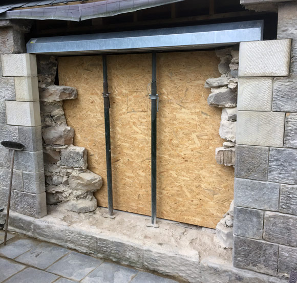 restorative work on stone wall showing inside progress of build