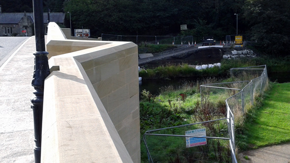 grade 2 listed bridge overlooking metal fenced off stream