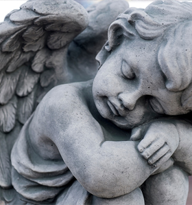 close up of stone monument of grave angel face