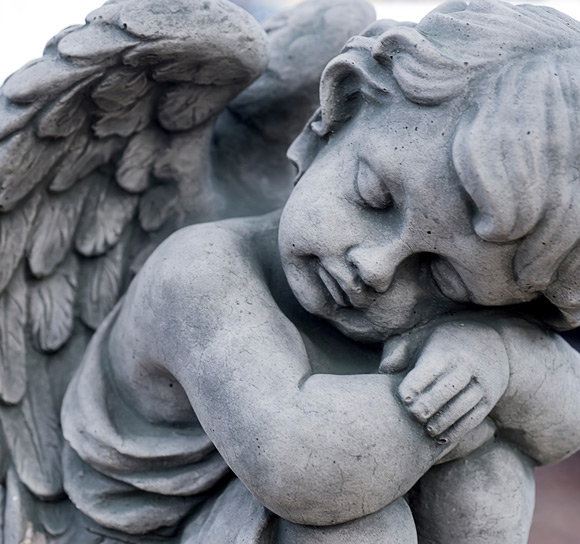 close up of stone monument of grave angel face